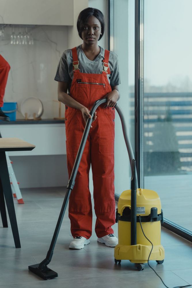 Cleaning technician vacuuming an office
